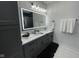 Bathroom features a double vanity with quartz countertop, and illuminated mirror at 2232 Central Ave, Indianapolis, IN 46205
