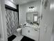 Modern bathroom featuring decorative lighting, marbled counter tops, and a stylish shower at 2232 Central Ave, Indianapolis, IN 46205