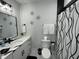 Modern bathroom features black hardware, stylish wall decor, a shower curtain, and white hexagon floor tiles at 2232 Central Ave, Indianapolis, IN 46205