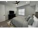 Well-lit bedroom with a large bed, ceiling fan, and hardwood floors at 2232 Central Ave, Indianapolis, IN 46205
