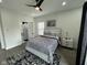 This is a bright bedroom featuring hardwood floors, a ceiling fan, and a door to an ensuite bathroom at 2232 Central Ave, Indianapolis, IN 46205