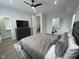 Bedroom view showcases the bed, interior doors, luxury vinyl flooring, and a TV on a dresser at 2232 Central Ave, Indianapolis, IN 46205