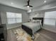 Cozy bedroom with a large bed, ceiling fan, and hardwood floors at 2232 Central Ave, Indianapolis, IN 46205