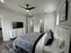 This bedroom features hardwood floors, a ceiling fan, and a door to an ensuite bathroom at 2232 Central Ave, Indianapolis, IN 46205
