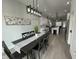 Open-concept dining room leading into the kitchen, with a black table and chairs at 2232 Central Ave, Indianapolis, IN 46205