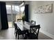 Dining room with a black table and chairs, pendant lighting, and sliding glass doors at 2232 Central Ave, Indianapolis, IN 46205