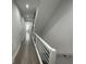 Bright hallway with hardwood floors, modern railing, and recessed lighting at 2232 Central Ave, Indianapolis, IN 46205