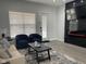 Living room with a black fireplace, two chairs, and a sofa on an area rug at 2232 Central Ave, Indianapolis, IN 46205
