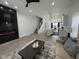 Open-concept living room with a fireplace, stairs, and kitchen in the background at 2232 Central Ave, Indianapolis, IN 46205
