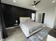 Spacious main bedroom with statement wall, ceiling fan, luxurious bed and ample natural light at 2232 Central Ave, Indianapolis, IN 46205