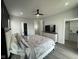 Bright main bedroom features a ceiling fan, TV, large bed, closet and natural light at 2232 Central Ave, Indianapolis, IN 46205