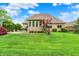 Expansive backyard with mature trees, lush lawn, and brick home exterior, great for outdoor enjoyment at 2507 Silver Oaks Dr, Carmel, IN 46032