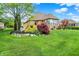 Beautiful backyard with manicured lawn, brick home, and mature trees, creating a tranquil retreat at 2507 Silver Oaks Dr, Carmel, IN 46032
