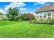 Lush backyard with mature trees and landscaped garden beds, providing a tranquil outdoor setting at 2507 Silver Oaks Dr, Carmel, IN 46032