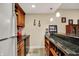 A kitchen bar area includes updated cabinets, wine storage, and granite counters at 2507 Silver Oaks Dr, Carmel, IN 46032