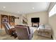 Entertainment space with a large flat-screen TV, seating, and a view of the stairway at 2507 Silver Oaks Dr, Carmel, IN 46032