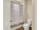 Bathroom featuring a toilet, shower, and a patterned shower curtain at 2507 Silver Oaks Dr, Carmel, IN 46032