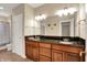 Bathroom with double sink vanity, granite countertop, wood cabinets, and neutral paint at 2507 Silver Oaks Dr, Carmel, IN 46032