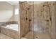Elegant bathroom features a luxurious soaking tub and separate walk-in shower with attractive tile and glass enclosure at 2507 Silver Oaks Dr, Carmel, IN 46032