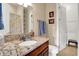 Bathroom boasts a beautiful marble countertop, a functional sink, and is complimented by wooden cabinets at 2507 Silver Oaks Dr, Carmel, IN 46032