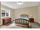 Cozy bedroom with soft carpet, a window, and a classic wood bed and dresser at 2507 Silver Oaks Dr, Carmel, IN 46032
