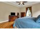 A primary bedroom with tray ceilings, crown moulding and warm hardwood floors and ensuite bath at 2507 Silver Oaks Dr, Carmel, IN 46032