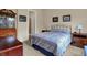 Cozy bedroom with a patterned quilt, decorative wall art, and furniture; adjacent bathroom visible through doorway at 2507 Silver Oaks Dr, Carmel, IN 46032