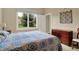Light-filled bedroom showcases a comfortable bed, complemented by a wooden dresser and a picturesque window view at 2507 Silver Oaks Dr, Carmel, IN 46032