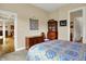 Inviting bedroom featuring a wooden desk, decorative quilt, and a view into an ensuite bathroom at 2507 Silver Oaks Dr, Carmel, IN 46032