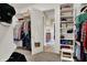 Spacious walk-in closet with custom shelving provides ample storage and organization; bathroom view visible through the closet at 2507 Silver Oaks Dr, Carmel, IN 46032