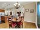Open-concept living space with dining area, wooden table, and kitchen in background at 2507 Silver Oaks Dr, Carmel, IN 46032