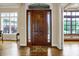 Inviting front entrance with a wooden door, sidelights, and hardwood floors visible from the foyer at 2507 Silver Oaks Dr, Carmel, IN 46032