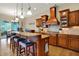 Spacious kitchen features wooden cabinetry, granite countertops and an island with seating at 2507 Silver Oaks Dr, Carmel, IN 46032