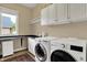 The laundry room includes a large window, counter space, and built in cabinets at 2507 Silver Oaks Dr, Carmel, IN 46032