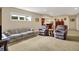 Cozy living area features a floral couch, two armchairs, bar, and carpeted floors at 2507 Silver Oaks Dr, Carmel, IN 46032