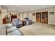 Spacious living room with plush carpet, two armchairs, and dark wood bookcases at 2507 Silver Oaks Dr, Carmel, IN 46032