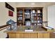 Home office boasting a large desk and a custom, built in bookshelf at 2507 Silver Oaks Dr, Carmel, IN 46032