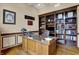 Office with built in wood shelving, hardwood floors, wood trim and neutral paint at 2507 Silver Oaks Dr, Carmel, IN 46032