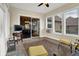 Bright sunroom with tile floor, multiple windows and views to the adjacent dining area at 2507 Silver Oaks Dr, Carmel, IN 46032