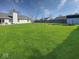 Large backyard with lush green grass, a storage shed, and mature trees at 2623 Kirk Ct, Lebanon, IN 46052