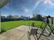 Backyard view featuring a large, green lawn, patio, and a swing at 2623 Kirk Ct, Lebanon, IN 46052