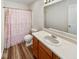 The bathroom features wood-look flooring, single sink vanity, and a shower-tub combo with curtain at 2623 Kirk Ct, Lebanon, IN 46052