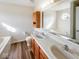 Bathroom featuring wood-look flooring, double sink vanity, and a soaking tub at 2623 Kirk Ct, Lebanon, IN 46052