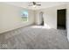 Carpeted bedroom featuring neutral walls, a ceiling fan, and large window at 2623 Kirk Ct, Lebanon, IN 46052