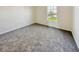This bedroom features neutral walls, carpeted floors, and a sunny window view of the outdoors at 2623 Kirk Ct, Lebanon, IN 46052