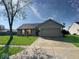 Well-kept single-story home featuring a two-car garage and mature landscaping at 2623 Kirk Ct, Lebanon, IN 46052