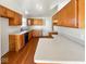 Functional kitchen featuring wood cabinets, laminate countertops, and hardwood floors at 2623 Kirk Ct, Lebanon, IN 46052