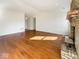 Spacious living room featuring hardwood floors and a cozy brick fireplace at 2623 Kirk Ct, Lebanon, IN 46052