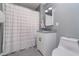 A well-lit bathroom featuring a white vanity and a shower with a neutral-patterned curtain at 2735 S Taft Ave, Indianapolis, IN 46241