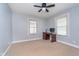 A serene bedroom with carpeted floors, complemented by natural light streaming through the window and a ceiling fan at 2735 S Taft Ave, Indianapolis, IN 46241